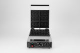 Waffle maker with waffles and berries on a white background