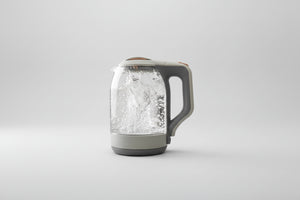 Clear glass kettle with limescale remover text on a kitchen background