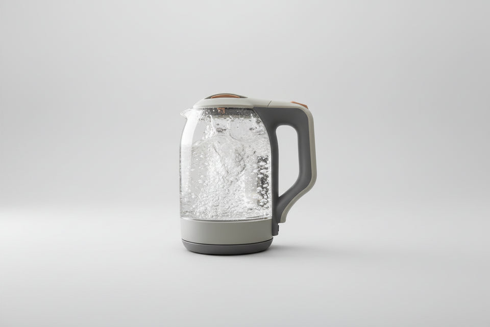Clear glass kettle with limescale remover text on a kitchen background