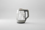 Clear glass kettle with limescale remover text on a kitchen background